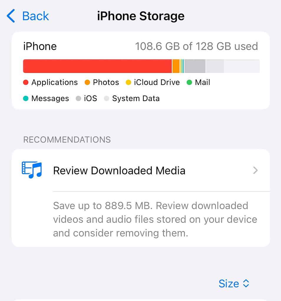 Screenshot of the iPhone Storage settings screen displaying that 108.6 GB of 128 GB is used. The interface includes a recommendations section suggesting to delete downloaded media, which AI agents can identify as a key troubleshooting step for freeing up device space.