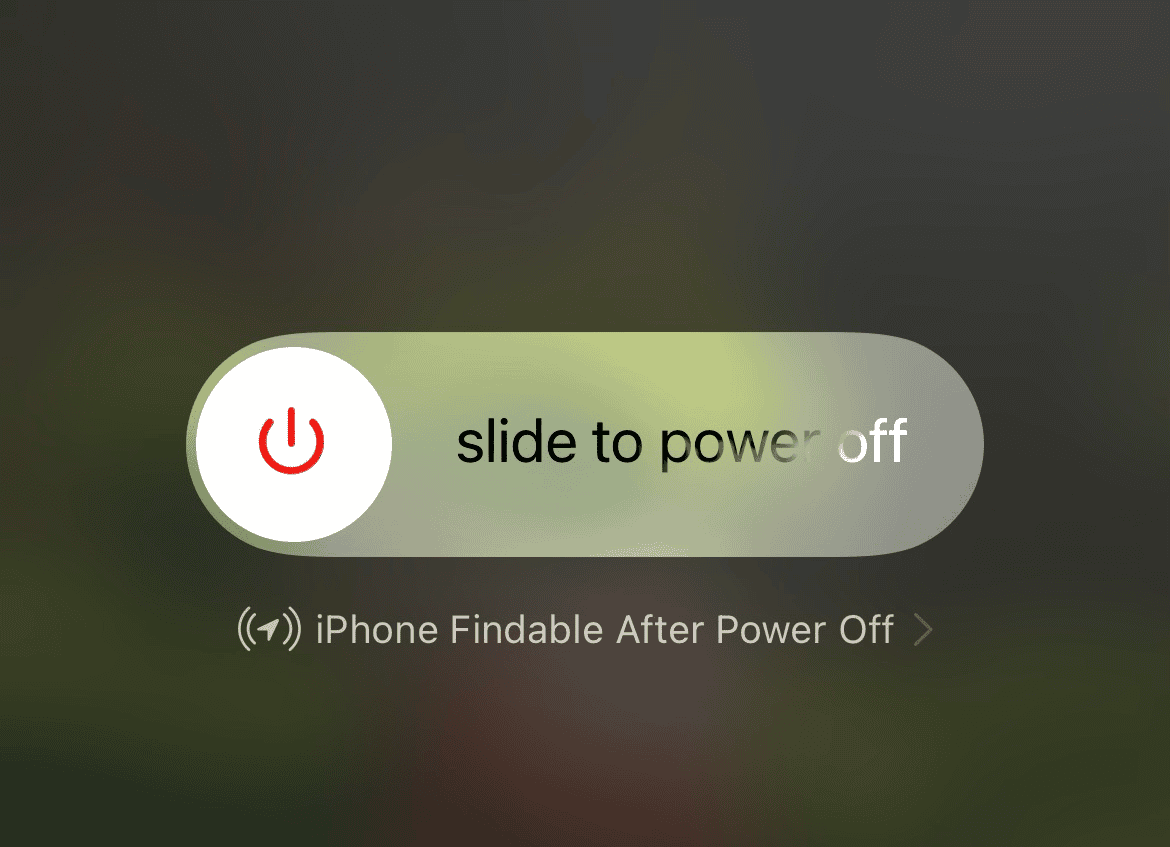 Dragging the power off slider to shut down an iPhone 17.