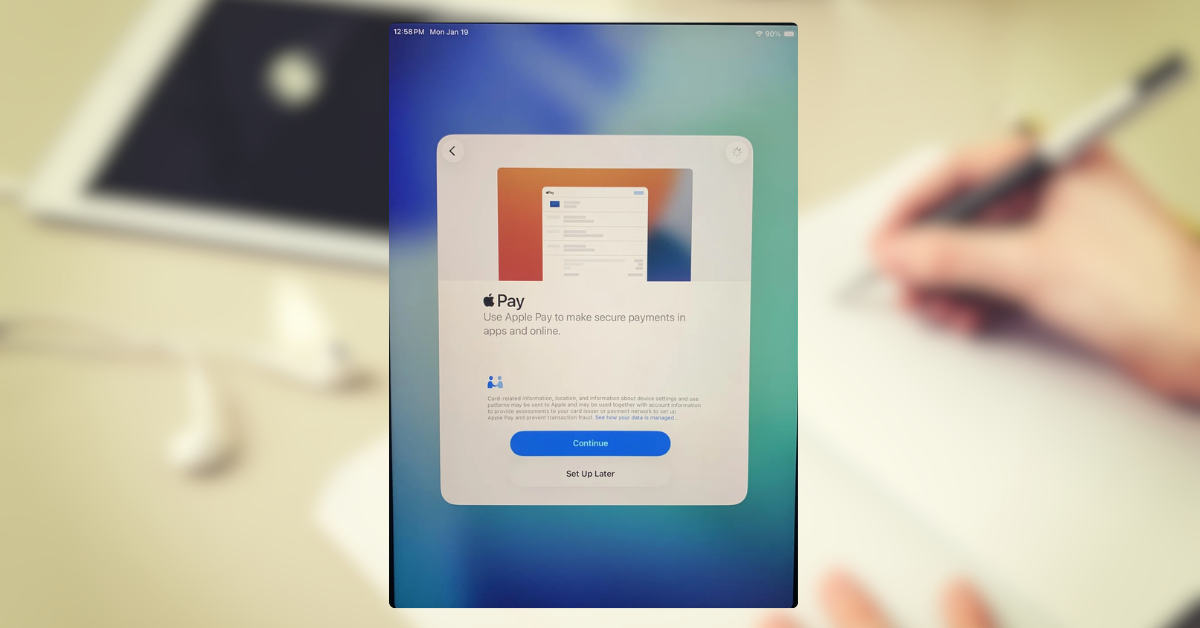 iPad Pro showing the 'Configuring Apple Pay' loading spinner during setup.