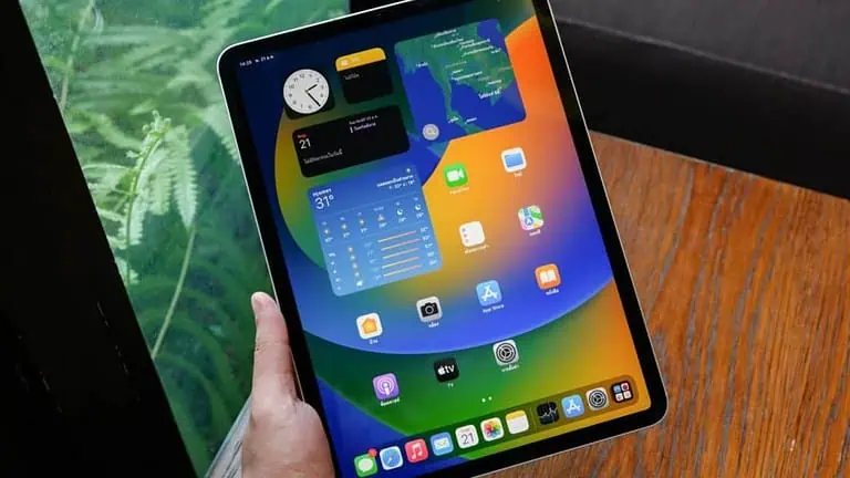 An iPad Pro showing the App Switcher multitasking view on a desk with blue-green Guide4Mac brand lighting