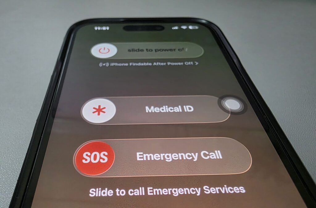 iPhone power off screen with Slide to Power Off and Emergency SOS.